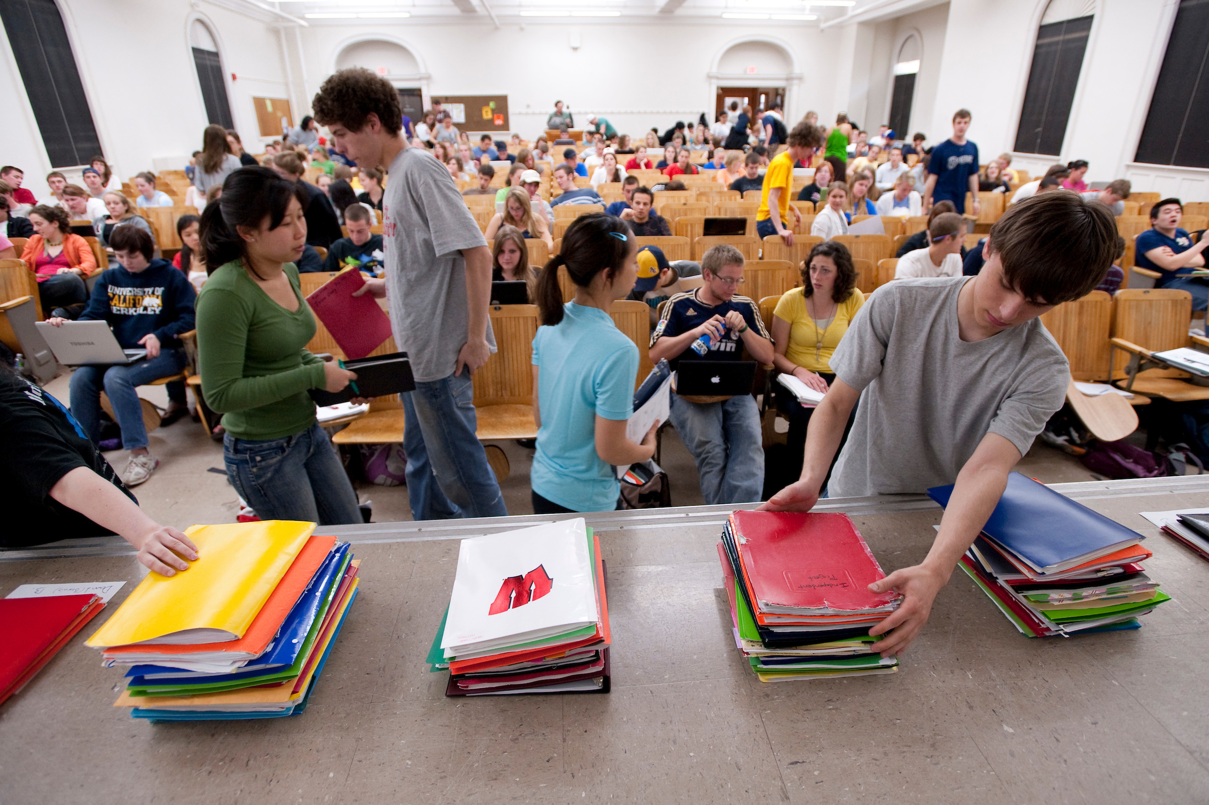 Students turn in their end-of-the-semester project folders during Introductory Biology 152, a required course for biology majors, held in a large lecture hall in Bascom Hall at the University of Wisconsin-Madison on April 30, 2009. The class is taught by Sara Hotchkiss, assistant professor of botany. ©UW-Madison University Communications 608/262-0067 Photo by: Jeff Miller Date: 04/09 File#: NIKON D3 digital frame 9494